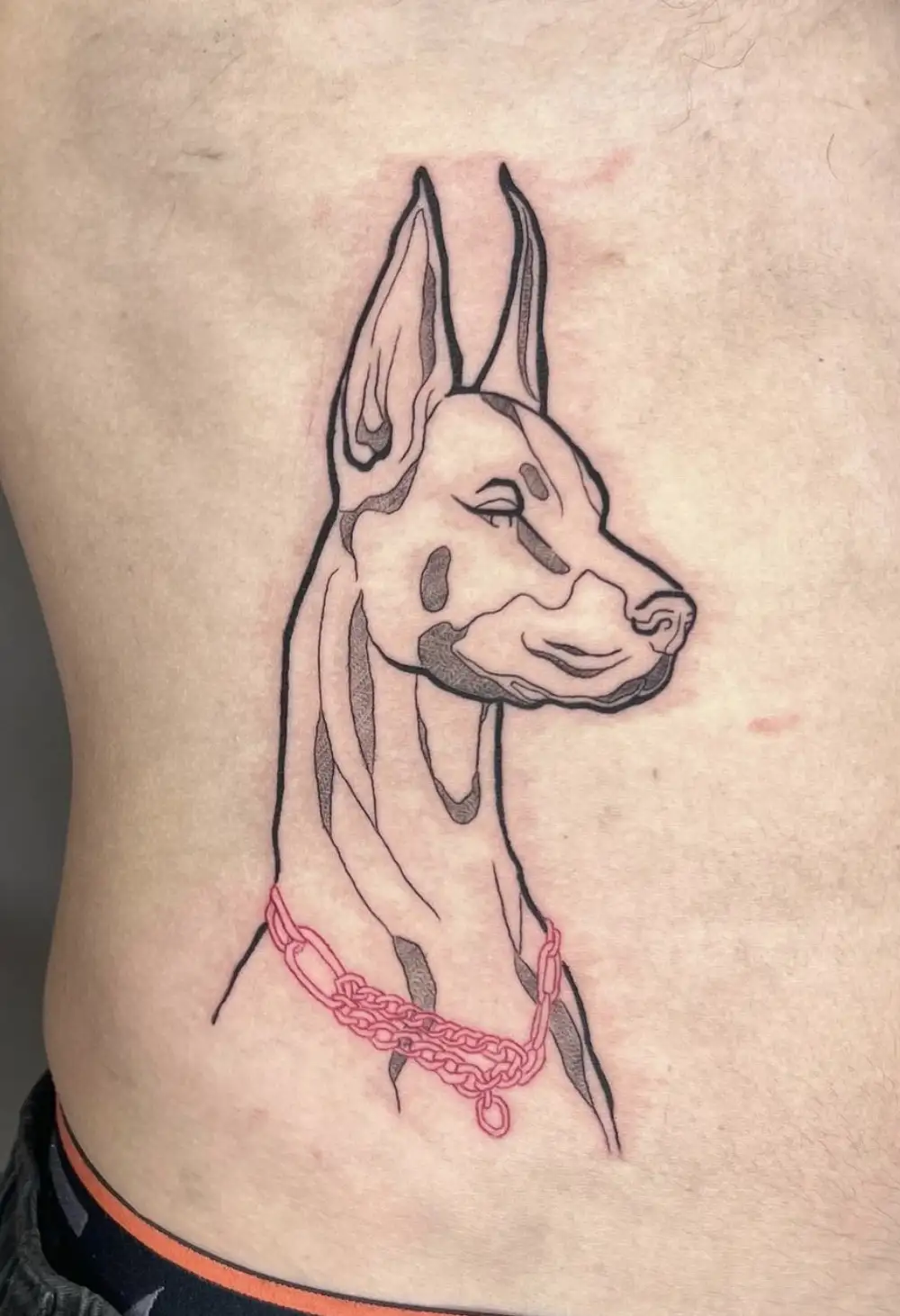 Doberman dog portrait tattoo with minimal lines and red collar by Ayah at Omnia Tattoo Melbourne